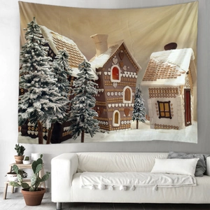 Détail d'une tapisserie de Noël avec maison en pain d'épices au-dessus d'un canapé blanc