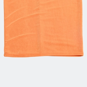 Close-up of orange knitted fabric showing double-needle hem stitching and texture