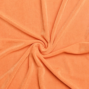 Detailed texture of orange ribbed knit fabric for a bodycon dress showing soft drape