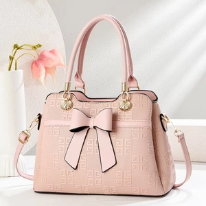 Pink lady handbag with large bow and geometric texture, handheld and shoulder bag style