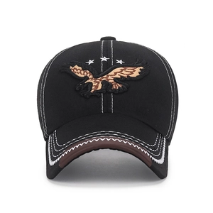 Black baseball cap with eagle embroidery and contrast stitching on a brown leather brim