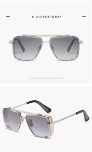Detail view of silver square sunglasses with side mesh frame and grey gradient lenses