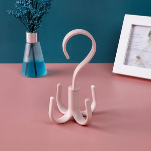 Pink rotatable four-claw hanger for organizing scarves, belts, and bags in wardrobes