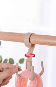 Close-up of beige 360-degree rotating 4-prong hanger storage hook for scarves and bags