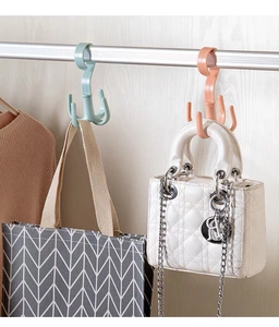 Close-up of rotatable four-claw plastic hangers for scarves and bags in pink and cyan colors