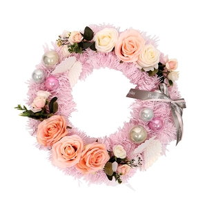 Pink Christmas wreath with faux roses, green leaves, and decorative balls for home wall decor