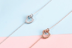 Detail of silver and rose gold hollow heart necklaces with sparkling small crystals