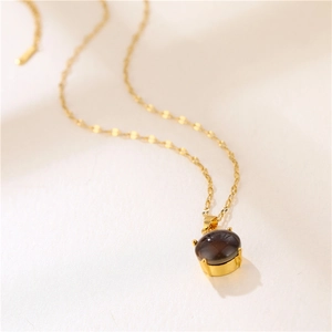 Golden titanium steel necklace with a round color-changing stone teardrop pendant