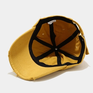 Internal view of a yellow cotton distressed baseball cap with worn edge details
