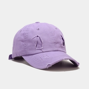 Detailed side view of lavender distressed cotton baseball cap with ripped hole texture