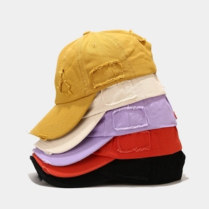 Distressed vintage cotton baseball caps in five stacked colors with worn-out edge design