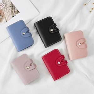 High capacity leather card holder with 26 slots in vibrant colors and metal button