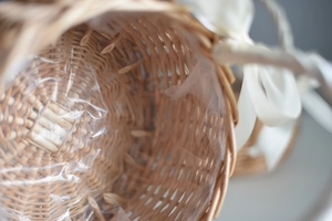 Detail of woven wicker basket showing waterproof liner and natural wood craftsmanship