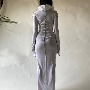 Detail view of the back seam of a white hooded long sleeve slim fit maxi bodycon dress