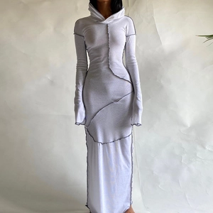 Detail of white hooded maxi dress with exposed dark contrast stitching and slim fit