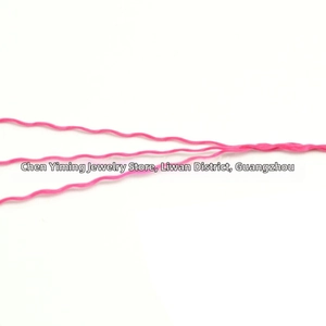 Close-up of pink crinkled polyester thread for DIY jewelry making and weaving projects