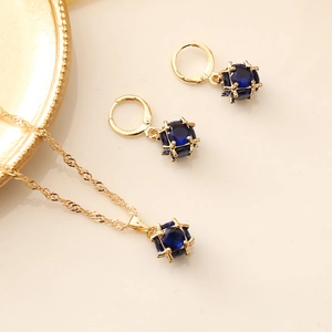 Detail of square blue crystal necklace and earrings set with gold-plated metal frames