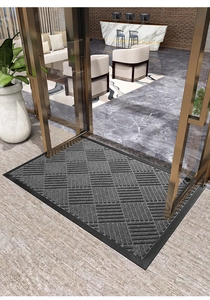 Gray non-slip door mat with woven texture and rubber border in a luxury hotel lobby