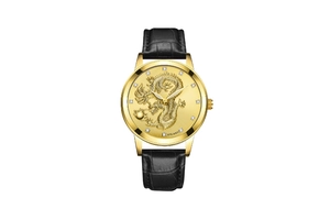 Detailed view of golden dragon relief dial with rhinestone markers and leather strap