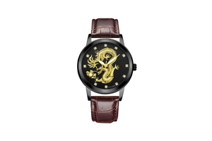 Detail of golden dragon relief dial with crystal markers on a black quartz watch