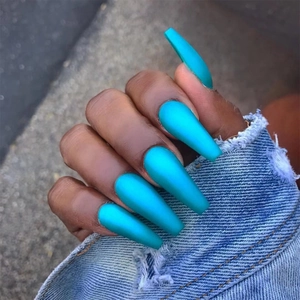 Matte bright blue long coffin press-on nails on denim background for a modern look