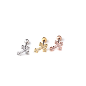 Close-up of cross stud earrings in silver, gold, and rose gold with inlaid zircon stones