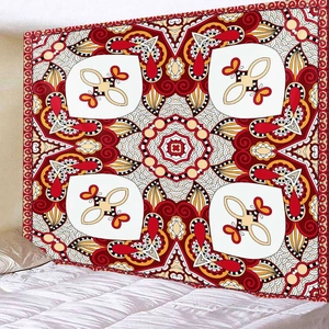 Close-up of ethnic mandala tapestry with red and yellow geometric patterns on bedroom wall