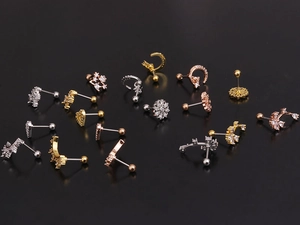 Macro shot of assorted stainless steel screw-back studs with zircons in various shapes