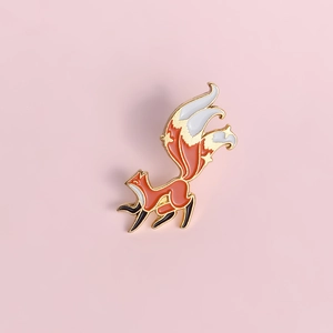 Creative orange enamel fox brooch pin with gold-plated alloy frame on pink background