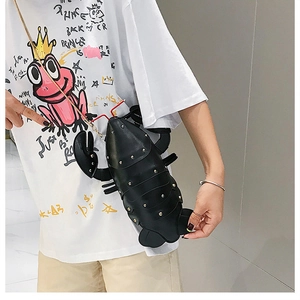 Detail of creative black lobster crossbody bag with gold studs and a chain strap