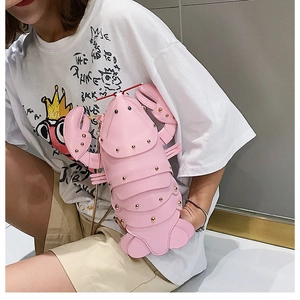 Detailed view of pink lobster bag with gold rivet accents and chic metal chain strap