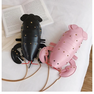 Close-up of pink and black lobster bags with shiny PU leather and gold studs