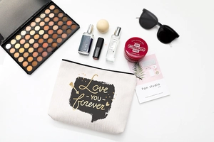 Detail of waterproof canvas cosmetic bag featuring gold Love YOU forever script
