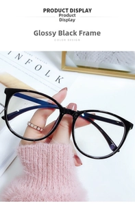 Detail of glossy black oversized glasses frame held by hand against a modern background