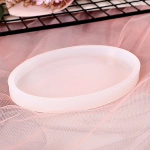 Macro detail of oval translucent silicone mold for DIY resin coasters on pink mesh fabric