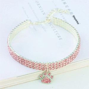 Close-up of triple-row pink rhinestone pet collar with a cute paw print charm pendant