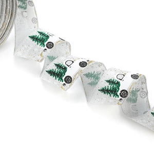 White linen Christmas ribbon with green trees and Merry Christmas text for gift wrapping