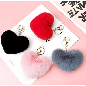 Detailed view of plush leopard print heart keychains in red, black, pink, and grey colors