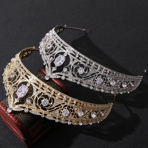 Detailed view of gold and silver bridal tiaras with crystals on a vintage wooden box