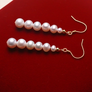 Elegant s925 silver hook earrings with six white gradient freshwater pearls on red velvet
