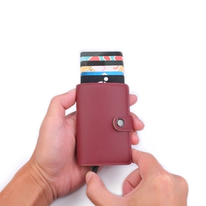 Detailed close-up of wine red PU leather wallet with automatic pop-up card mechanism