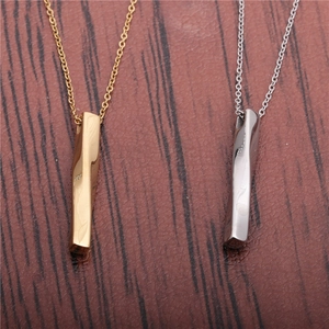 Minimalist twisted bar necklaces in gold and silver steel on a wood surface