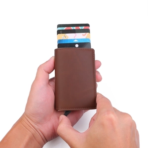 Brown leather wallet detail showing automatic pop-up cards triggered by manual slider