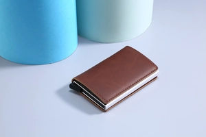 Brown leather RFID blocking aluminum wallet detail with card pop-up mechanism