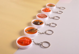 Macro detail of artificial seafood resin tray keychains with realistic crawfish and fish