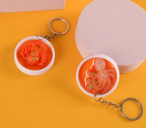 Macro detail of realistic mini seafood bowl pendants with crab and octopus designs