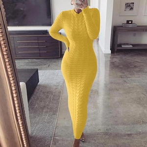 Detail of a bright yellow cable-knit maxi dress showing the texture and long sleeves