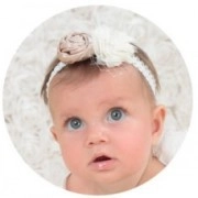 Detailed view of baby lace headband featuring champagne fabric flowers and soft pearls