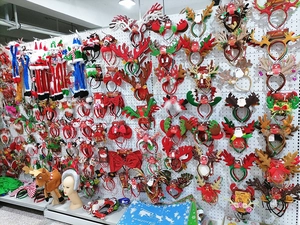 Massive selection of Christmas headbands and plush hats displayed on wholesale racks