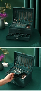 Three-layer dark green velvet jewelry box showing multi-grid drawers and necklace hooks